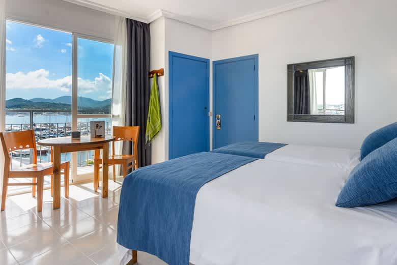 Surf and book in few minutes: Central comfortable holiday studio apartments in San Antonio de Portmany heart, overlooking the sea and port area, 2 min to West End and beach